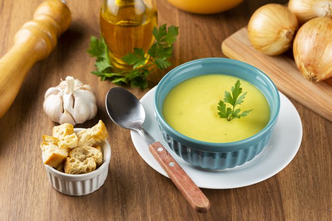 Bowl with onion soup and croutons on the table.