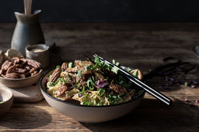 Miso noodles with egg plants and shiitake in bowl on table