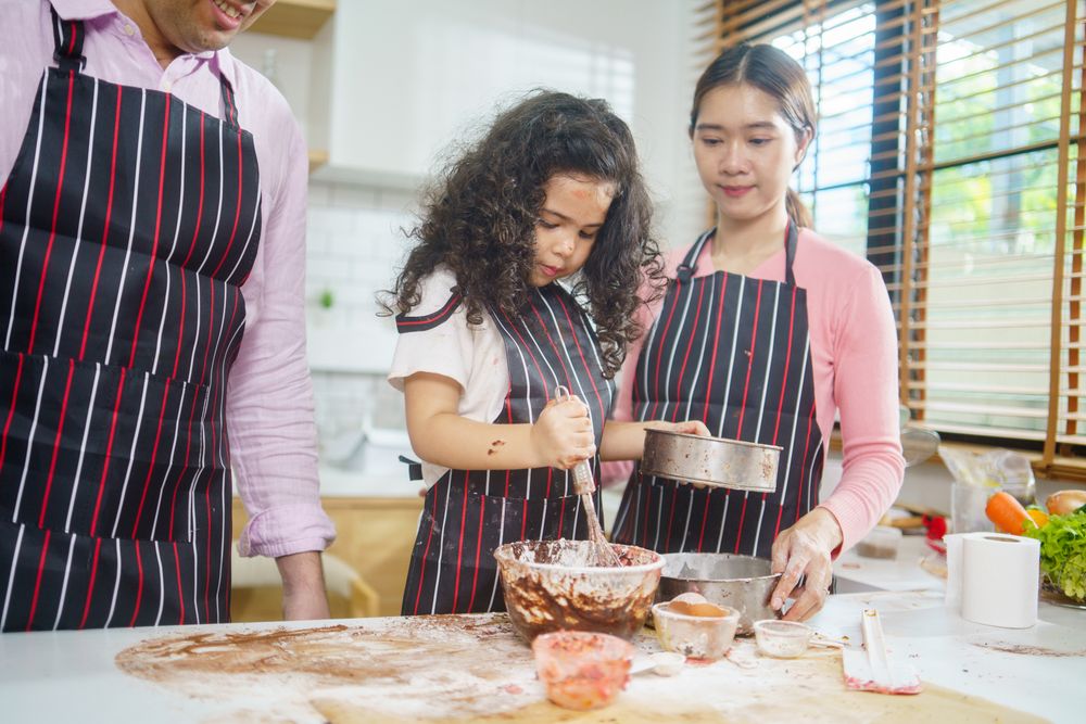 Happy family with child baking together in the kitchen