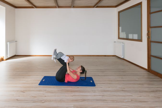 Mother exercising with baby in gym