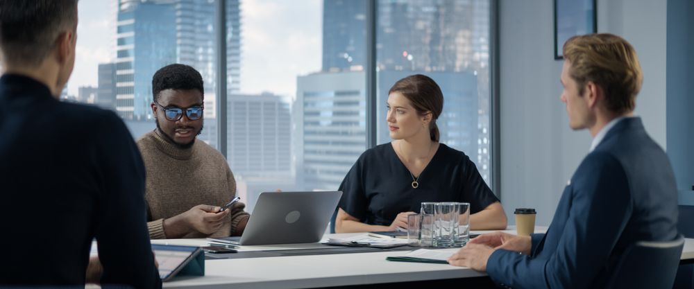 Office Conference Room Meeting: Diverse Team of Top Managers Talk, Brainstorm, Use Tablet and Laptop.