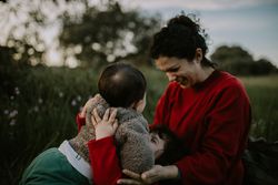 Mother, son and daughter laughing together in a park