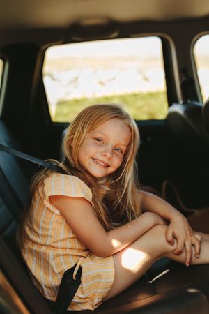 Beautiful girl travelling in backseat of the car