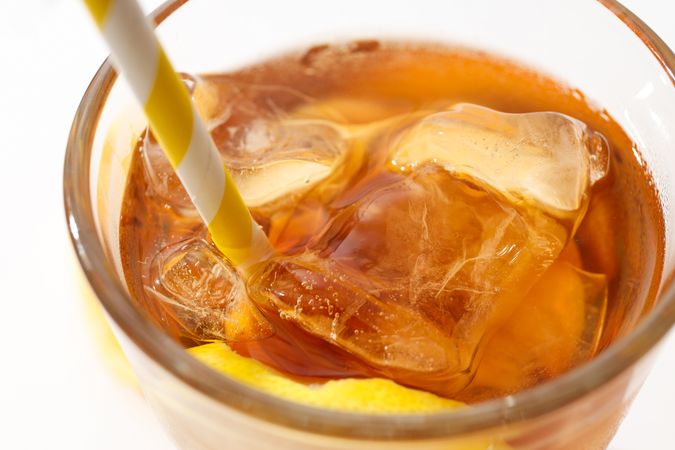 Glass of iced tea with orange slices close-up