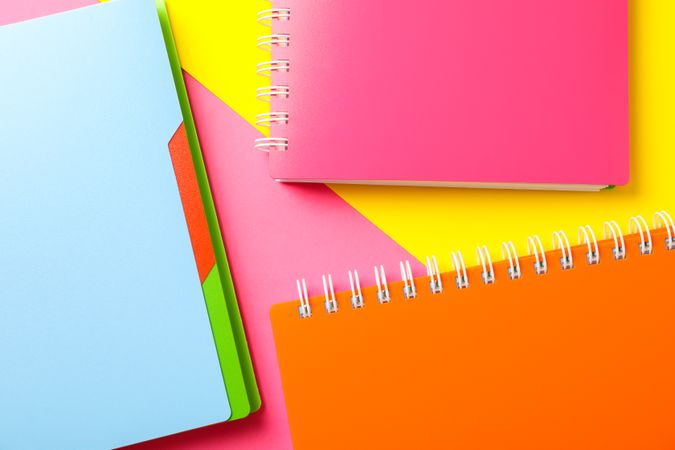 Composition with copybooks on two tone background, space for text