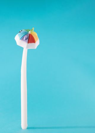 Umbrella standing on a sky blue background making shadow