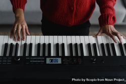 Cropped image of person playing musical keyboard 4BEnB5