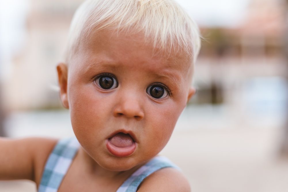Portrait of a blonde baby boy on the beach