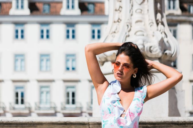 stylish woman in sunglasses sitting in street stairs