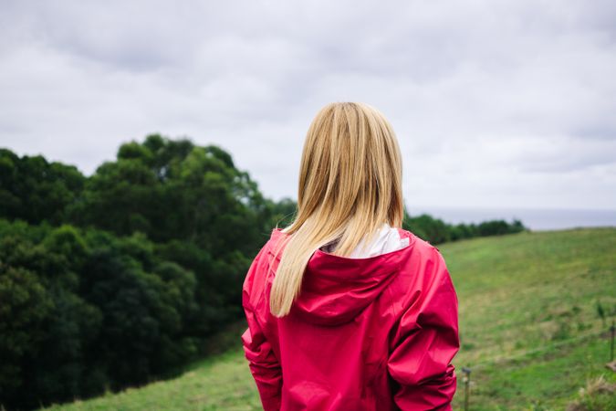 Woman standing in countryside and looking away