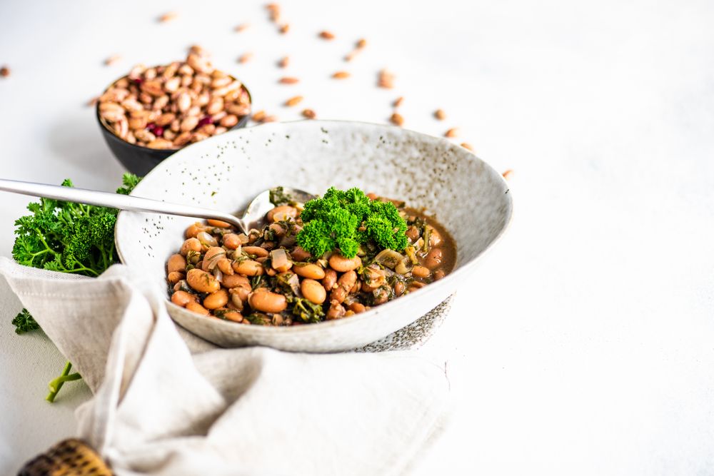Traditional Georgian bean dish - lobio, served in modern textured ceramic bowl with napkin