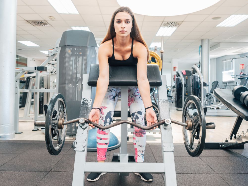 Young woman lifting barbell