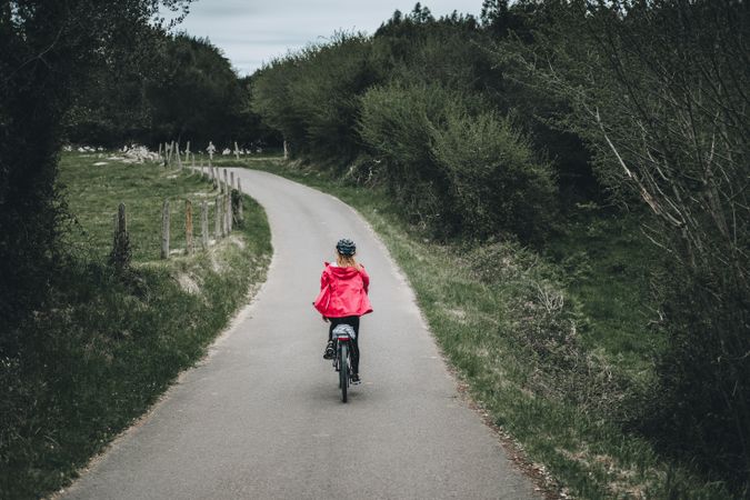 Female riding bicycle in countryside road