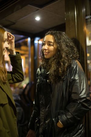 Two women in jackets talking outside