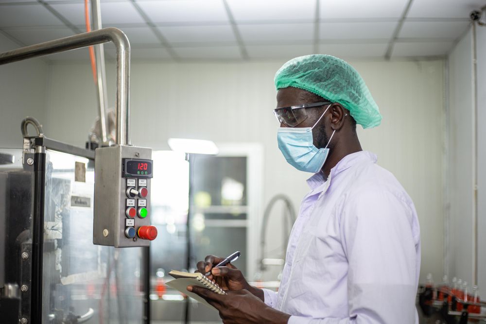 Man in hair net and PPE at food factory