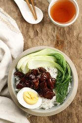 Top view of pork and rice dish with tea