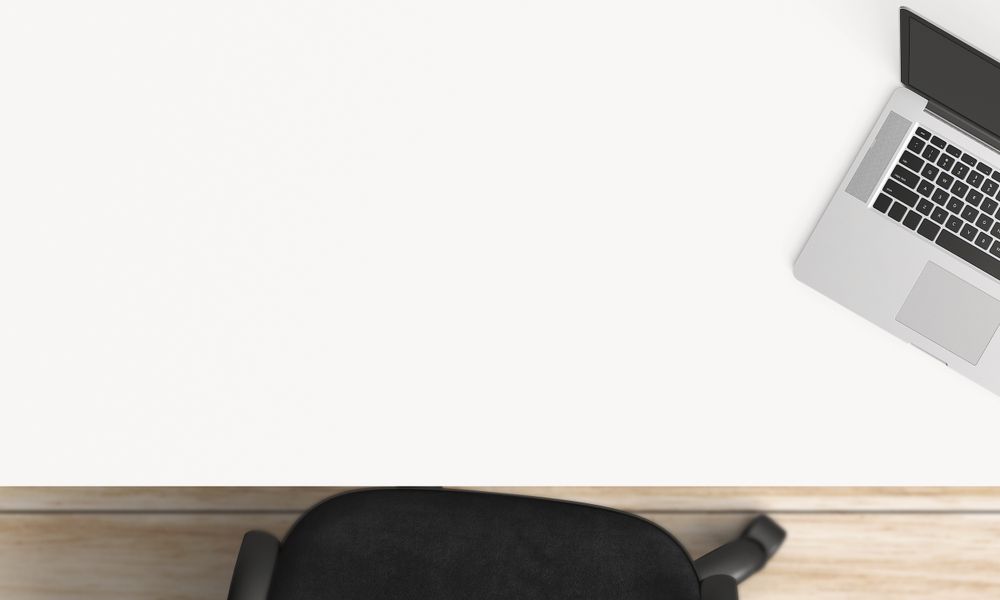 Modern workplace with laptop, coffee cup and notebook copy space on table background. Top view. Flat lay style.