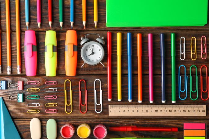 Flat lay composition with school supplies on wooden background