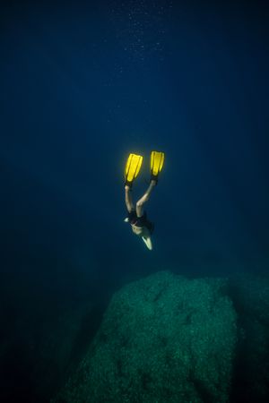 Diver in flippers swimming underwater