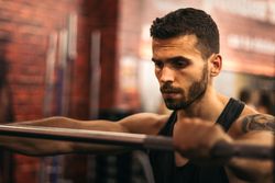 determined strong man focus on training in a gym
