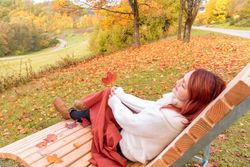Woman sitting on park bench enjoying the view