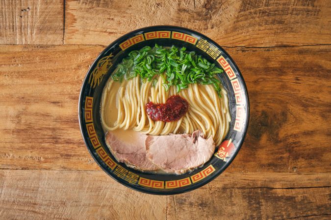 Tasty ramen with pork slices and salsa