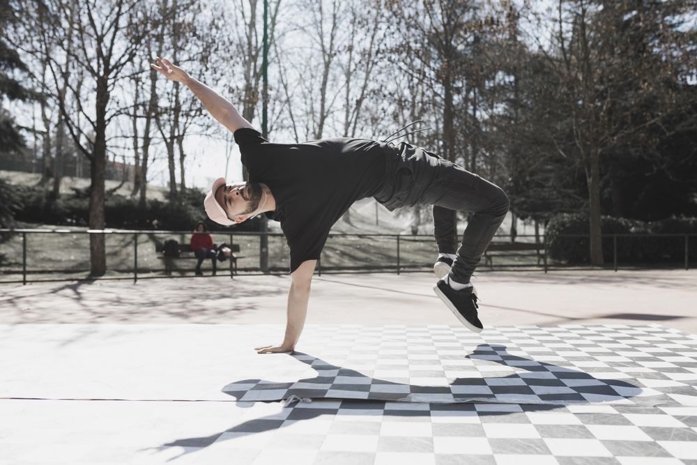 Man dancing break dance in park