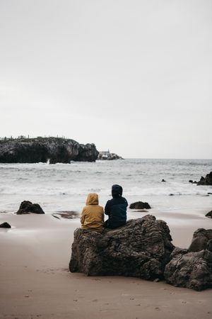 Anonymous people admiring waving sea