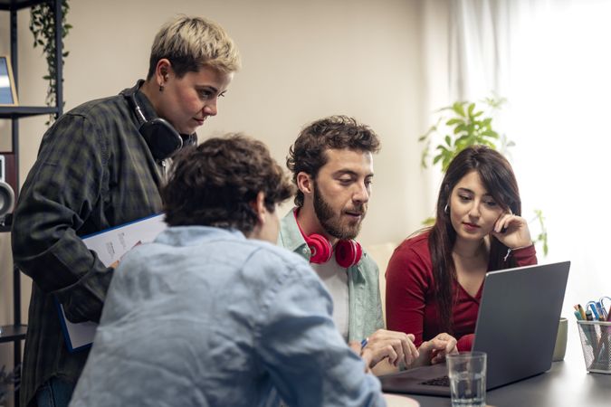 Diverse business team collaborating on a project in a modern startup office.