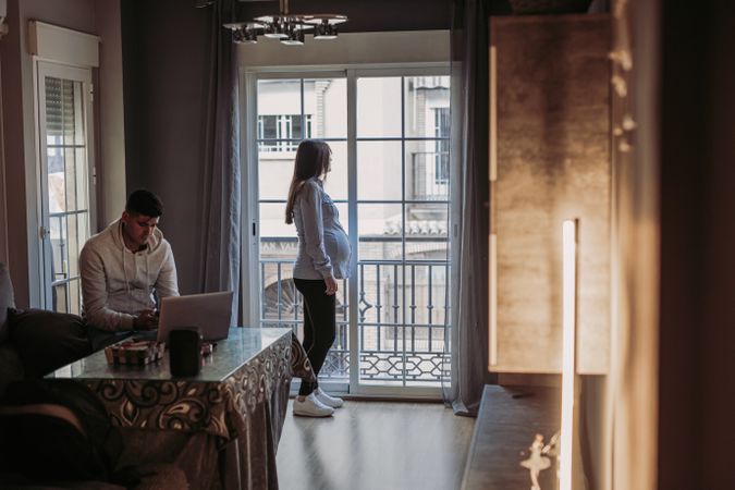Pregnant wife and husband spending time at home