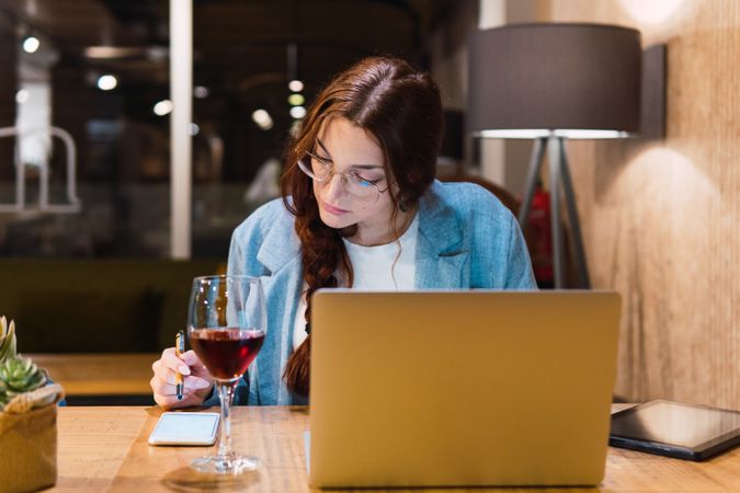 Focused female freelancer working in restaurant