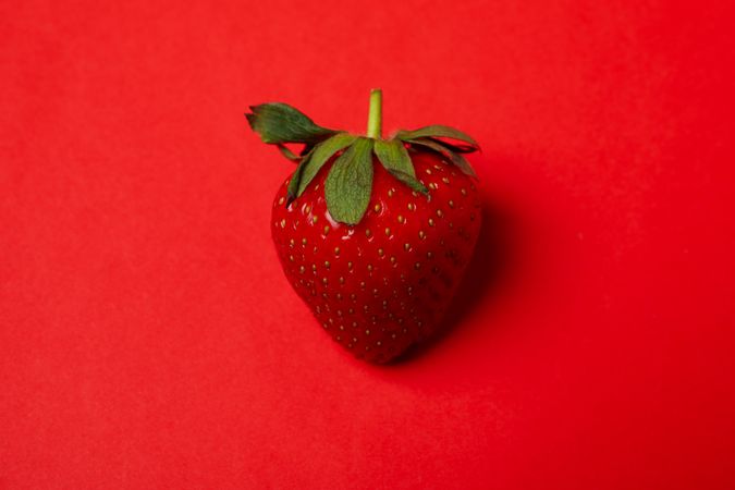 Tasty strawberry on red background. Summer berry