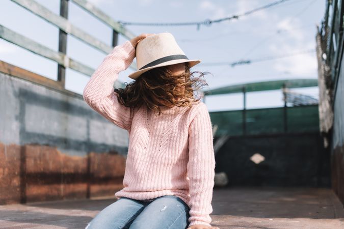 Focused girl resting in truck body