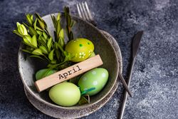 Easter card concept with pastel egg and branch adorning bowl