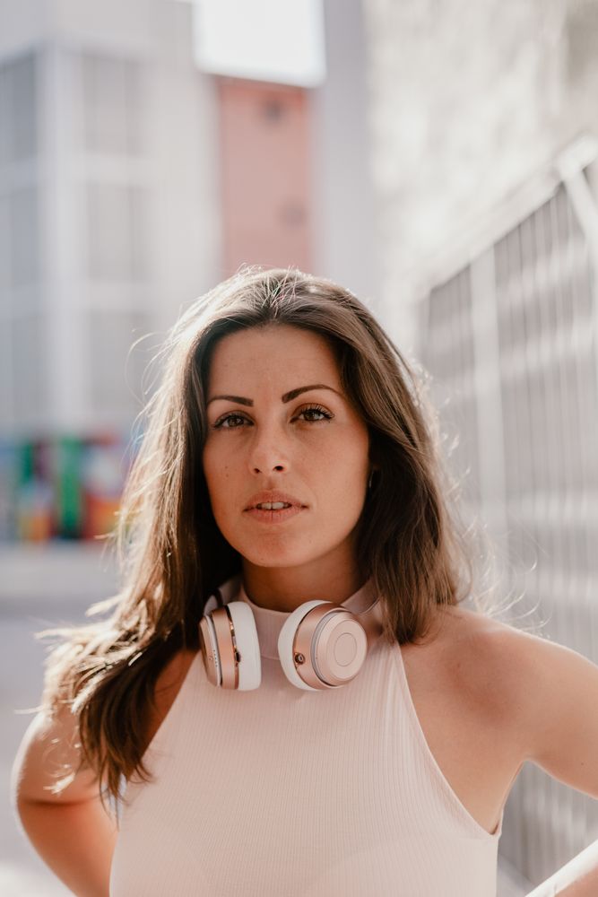 Brunette listening to music in sunlight