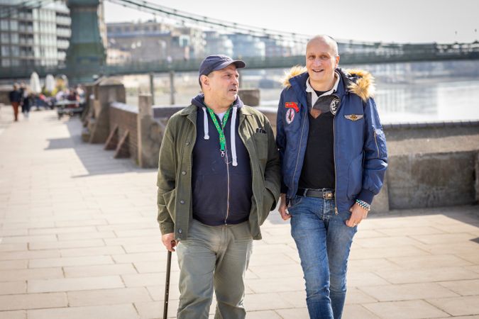 Two males walking along the Thames path in London