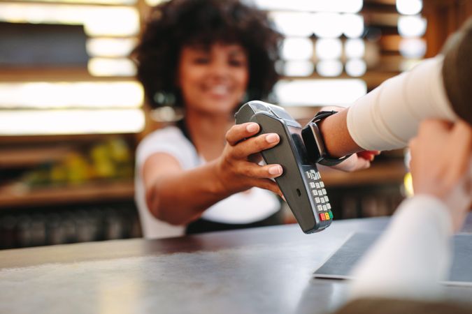 Cashier accepting payment over nfc technology