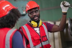 Factory worker with hand on lever