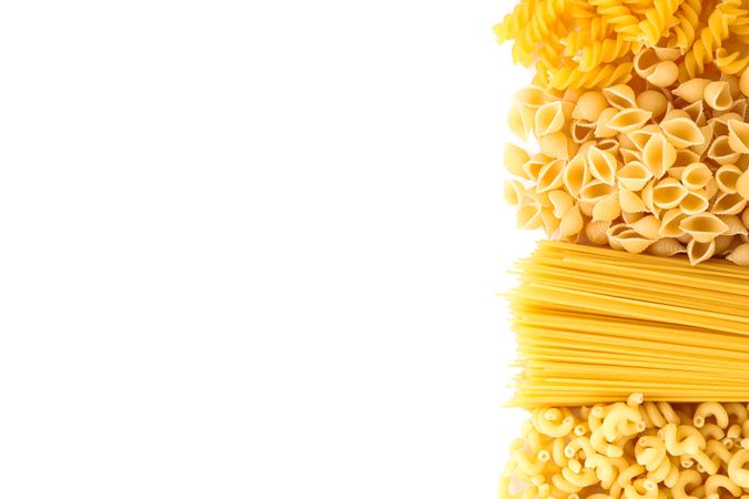 Pasta isolated on light background, top view. Dry uncooked whole pasta