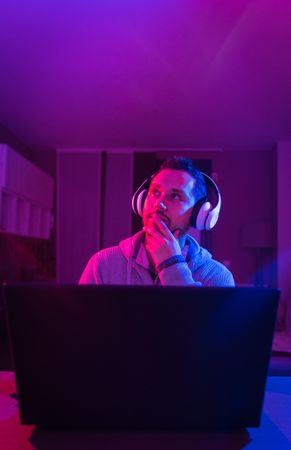 Man listening cheerfully to music with headphones.