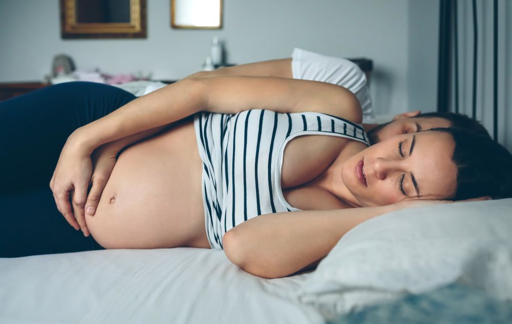 Man and pregnant woman sleeping
