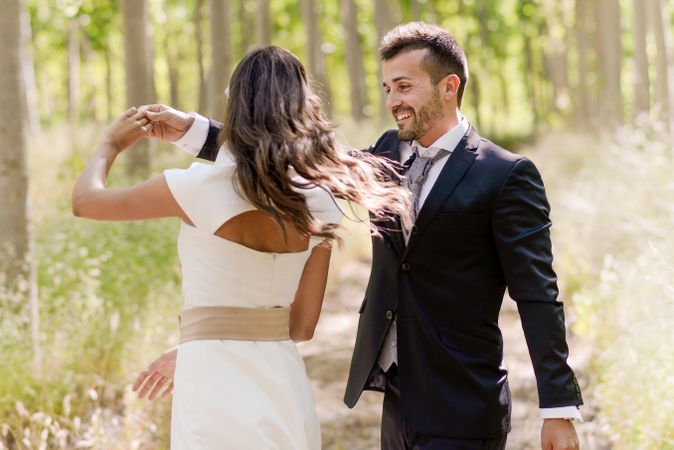 Newlyweds dancing together in nature