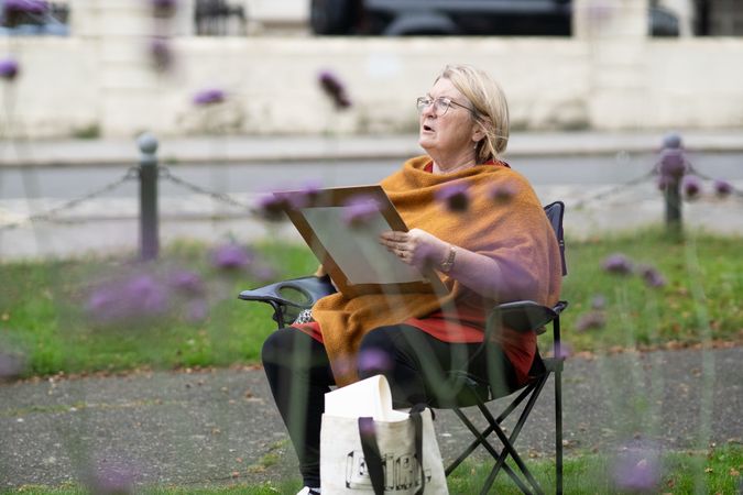 Woman drawing in field