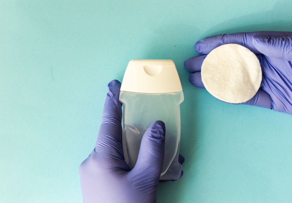 Covid-19 virus concept of hands in latex gloves holding cotton swabs and soap