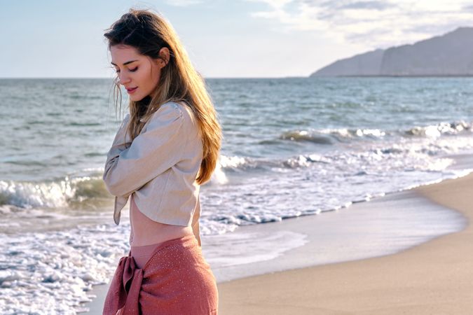 A fashion model at the beach before sunset