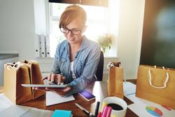 Female entrepreneur fulfilling orders from her home office