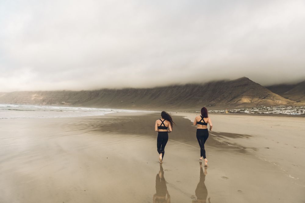 Anonymous women running near sea