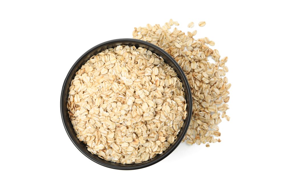 Bowl with oatmeal flakes isolated on plain background