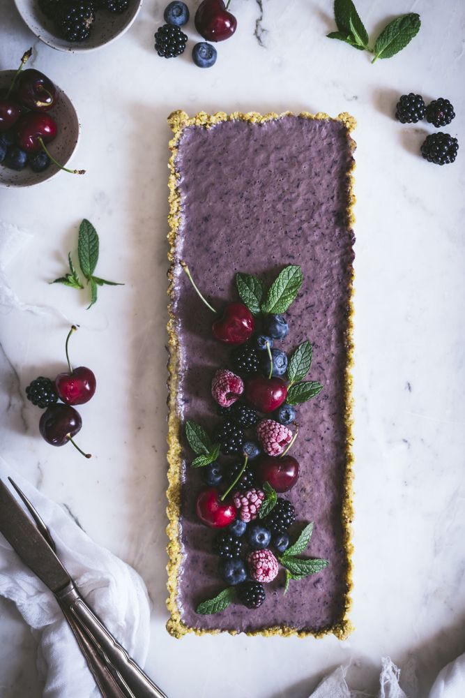 Fresh blueberry pistachio cake with whole berries on top