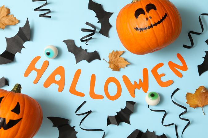 Text halloween and accessories on blue background